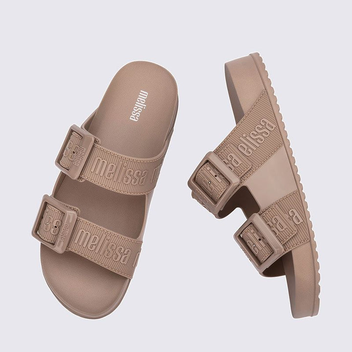 Chinelo adulto Melissa Cozy Slide M.Lover na cor bege, com duas tiras largas ajustáveis com fivelas e logo em relevo. Produzido em Melflex, com palmilha anatômica e solado tratorado. Ideal para looks casuais com conforto, estilo e praticidade.

Palavra-chave principal: Melissa Cozy Slide M.Lover
Palavras-chave relacionadas: chinelo bege, slide feminino, Melflex, tiras com fivela, palmilha anatômica, solado tratorado, calçado confortável.