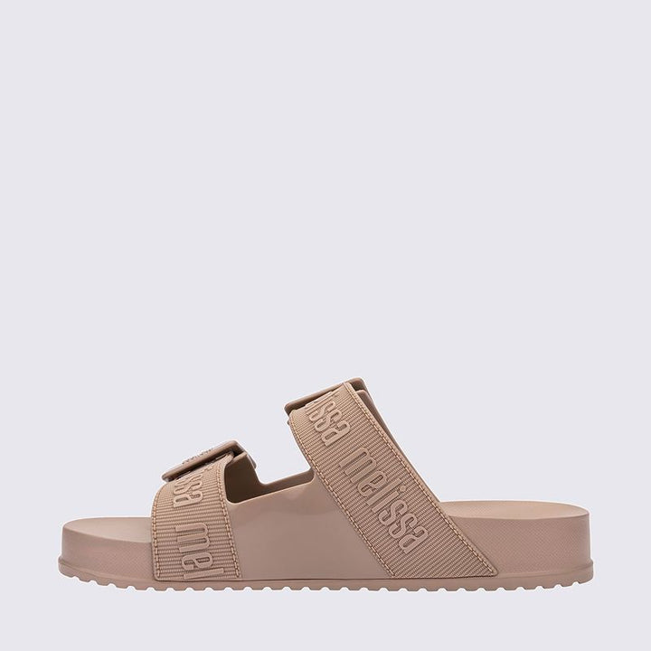 Chinelo adulto Melissa Cozy Slide M.Lover na cor bege, com duas tiras largas ajustáveis com fivelas e logo em relevo. Produzido em Melflex, com palmilha anatômica e solado tratorado. Ideal para looks casuais com conforto, estilo e praticidade.

Palavra-chave principal: Melissa Cozy Slide M.Lover
Palavras-chave relacionadas: chinelo bege, slide feminino, Melflex, tiras com fivela, palmilha anatômica, solado tratorado, calçado confortável.