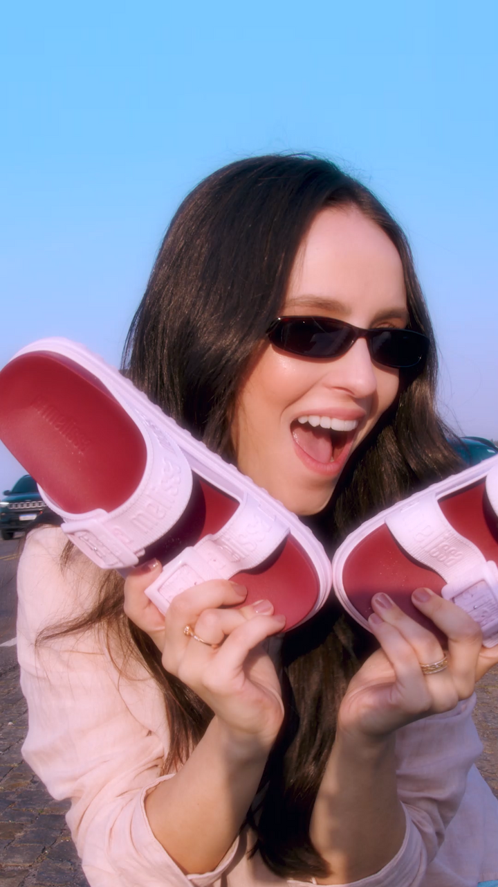 Sandália plataforma adulta Melissa Cozy M.Lover nas cores rosa e vermelho, com duas tiras largas ajustáveis com fivelas e logo em relevo. Produzida em Melflex, com solado tratorado alto e palmilha anatômica, combina conforto, estilo marcante e atitude nos looks casuais