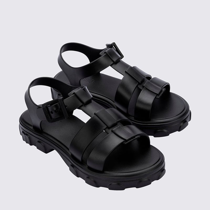 Sandália Melissa Ella na cor preta, com design minimalista, tiras finas e fecho ajustável no tornozelo. Produzida em Melflex, é leve, confortável e elegante, ideal para compor looks casuais e sofisticados com praticidade no dia a dia