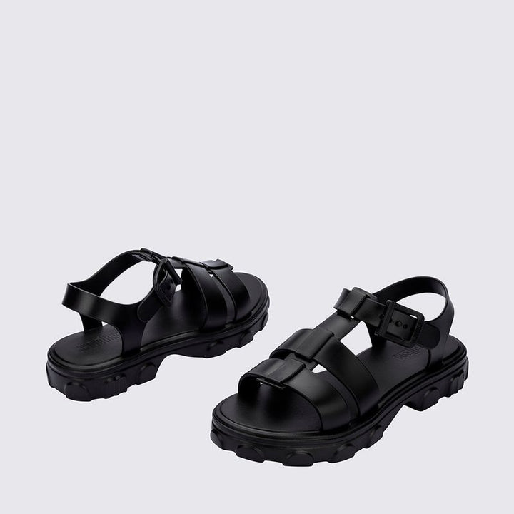 Sandália Melissa Ella na cor preta, com design minimalista, tiras finas e fecho ajustável no tornozelo. Produzida em Melflex, é leve, confortável e elegante, ideal para compor looks casuais e sofisticados com praticidade no dia a dia