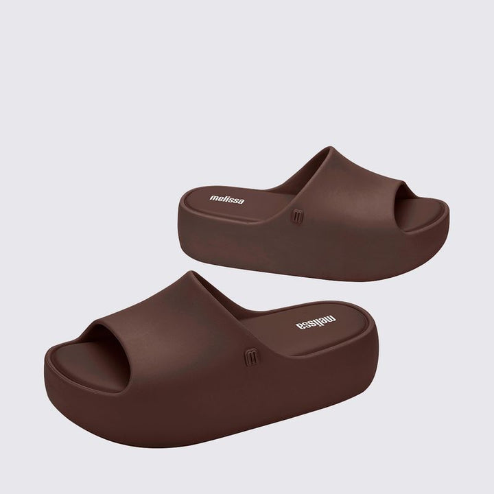 Sandália Melissa Free Platform Slide adulto na cor bronze, com tira larga, solado plataforma e design minimalista – calçado moderno, confortável e estiloso para o dia a dia.

Palavra-chave principal:
Melissa Free Platform Slide

Palavras-chave relacionadas:
Melissa 35859, sandália slide bronze, plataforma Melissa, slide feminino, calçado confortável Melissa, sandália metálica, Melissa com solado alto, sandália moderna, slide casual, sandália bronze adulta