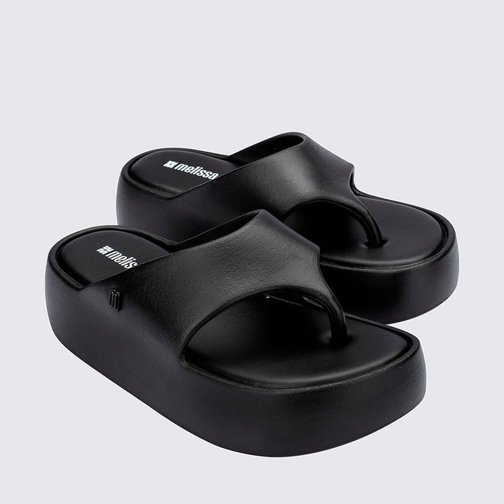 Sandália Melissa Free Platform Thong adulto na cor preta, com design de dedo, solado plataforma e tiras largas – calçado moderno, confortável e versátil para o dia a dia.

Palavra-chave principal:
Melissa Free Platform Thong

Palavras-chave relacionadas:
Melissa 36088, sandália de dedo preta, plataforma Melissa, calçado confortável Melissa, sandália moderna, tiras largas Melissa, Melissa preta adulto, chinelo plataforma, sandália casual feminina, slide Melissa adulto