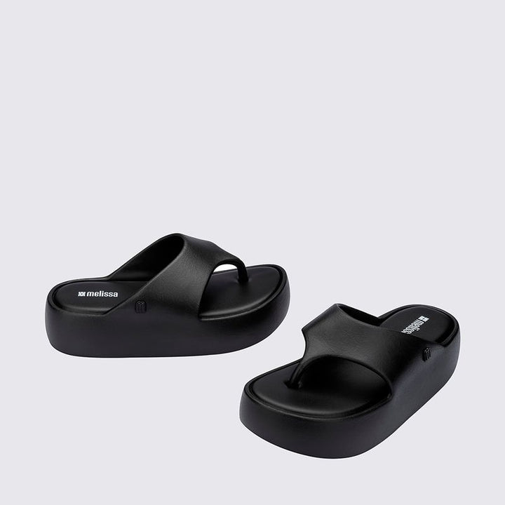 Sandália Melissa Free Platform Thong adulto na cor preta, com design de dedo, solado plataforma e tiras largas – calçado moderno, confortável e versátil para o dia a dia.

Palavra-chave principal:
Melissa Free Platform Thong

Palavras-chave relacionadas:
Melissa 36088, sandália de dedo preta, plataforma Melissa, calçado confortável Melissa, sandália moderna, tiras largas Melissa, Melissa preta adulto, chinelo plataforma, sandália casual feminina, slide Melissa adulto