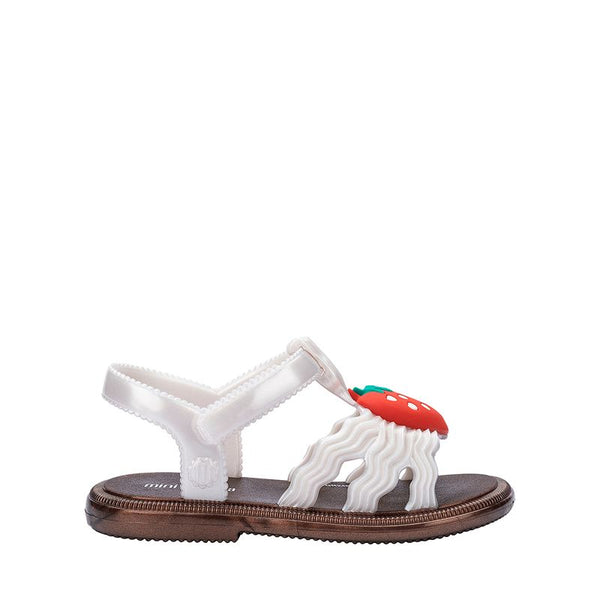 Sandália infantil Mini Melissa Hip Sandal Baby nas cores bronze e branco perolado, com tiras largas e fechamento em velcro. Produzida em Melflex, é leve, confortável e segura, perfeita para os primeiros passos com brilho delicado e muito estilo