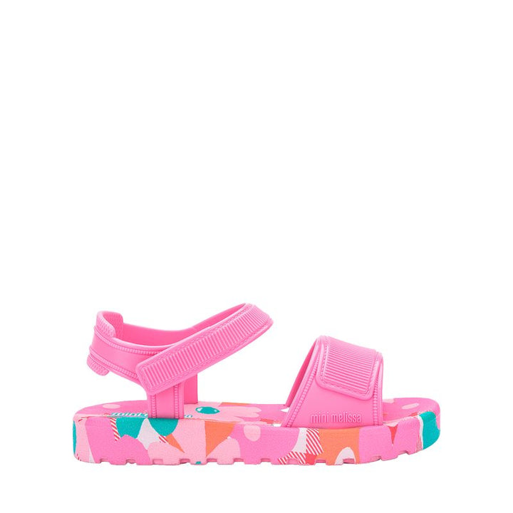 Sandália infantil Mini Melissa Imagine nas cores rosa e azul, com acabamento delicado e divertido. Produzida em material Melflex, leve, macio e confortável. Possui fechamento ajustável que oferece segurança aos primeiros passos das pequenas. Acompanha uma bolsinha combinando, com capacidade de 5 litros, ideal para carregar itens essenciais com praticidade, charme e estilo no dia a dia.