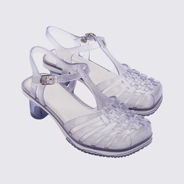 Sandália infantil Mini Melissa Vixen na cor branco com acabamento vidro e glitter. Modelo estiloso com tiras cruzadas e solado reto. Produzida em Melflex, leve, confortável e perfeita para compor looks modernos e divertidos para as crianças