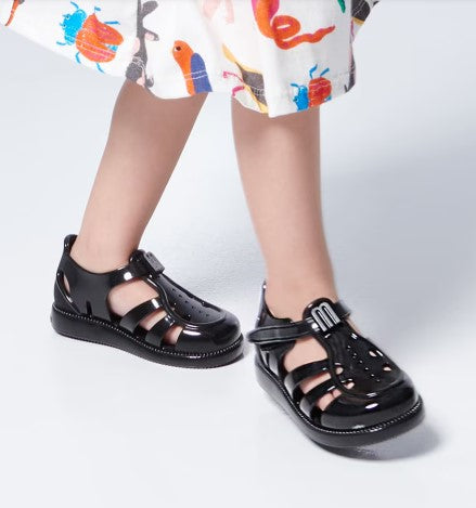 Sandália infantil Mini Melissa Hip Daydream Baby na cor preta, com tiras vazadas, fechamento em velcro e detalhe frontal com o 'M' da marca. Produzida em Melflex, é leve, confortável e segura, ideal para os primeiros passos com estilo e praticidade."

Palavra-chave principal: Mini Melissa Hip Daydream Baby
Palavras-chave relacionadas: sandália baby preta, Melflex, calçado infantil, fechamento em velcro, primeiros passos, conforto, estilo para bebês.